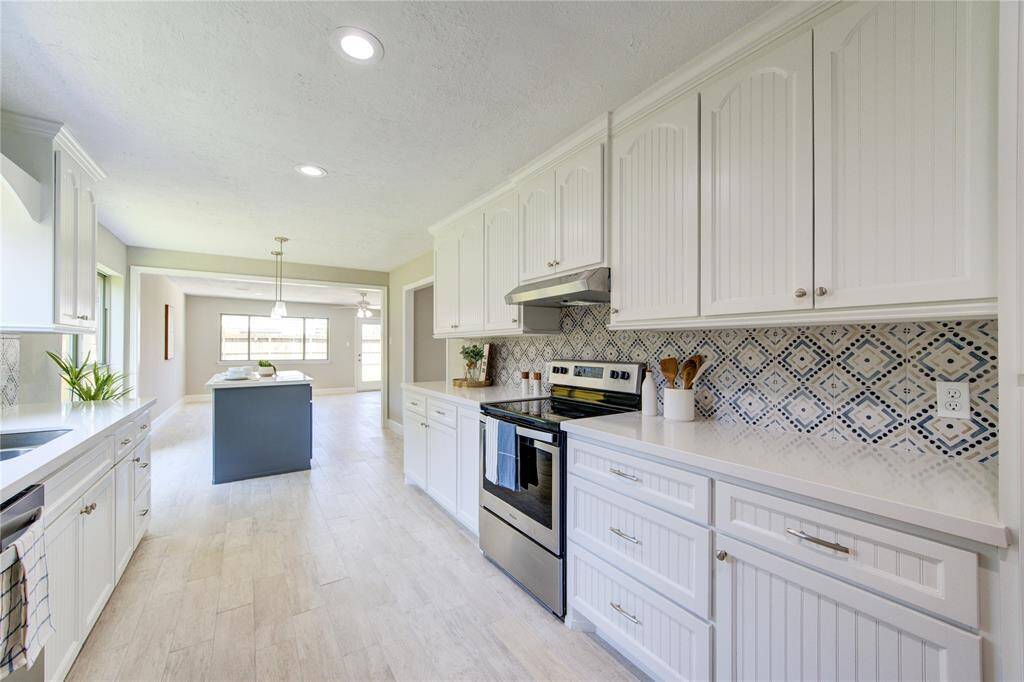 Quartz counters, custom built cabinets, beautiful backsplash creates stylish elegance.