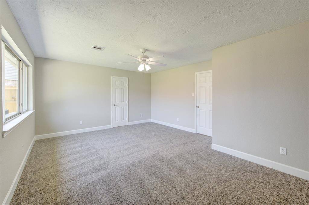 Under high ceilings, you will fall in love with the primary bedroom suite.  It offers plenty of room for a king-sized bed as well as plenty of other bedroom furniture.
