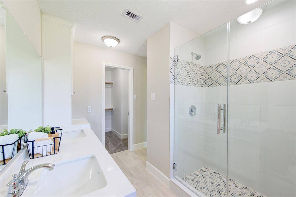 Take a look at the impressive frames shower that boasts plenty of space and stylish tile design.