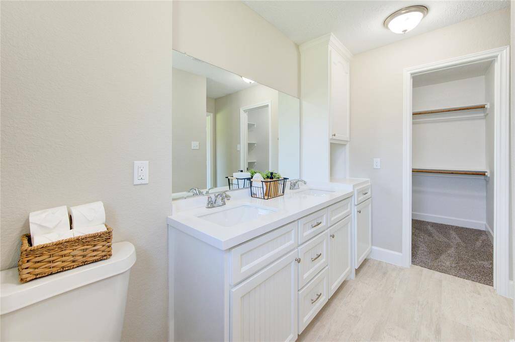 Another view of primary bath leading to impressive walk-in closet.