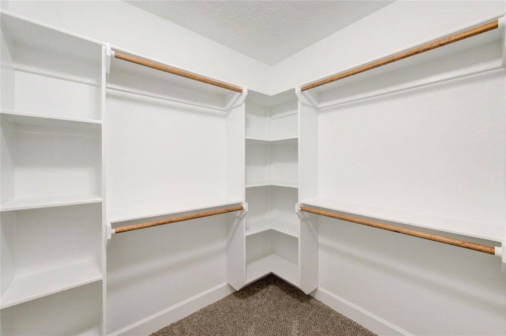 Everyone loves a walk-in custom built closet and this one doesn't disappoint!  Enjoy plenty of space for hanging and folded clothes, shoes and bags!
