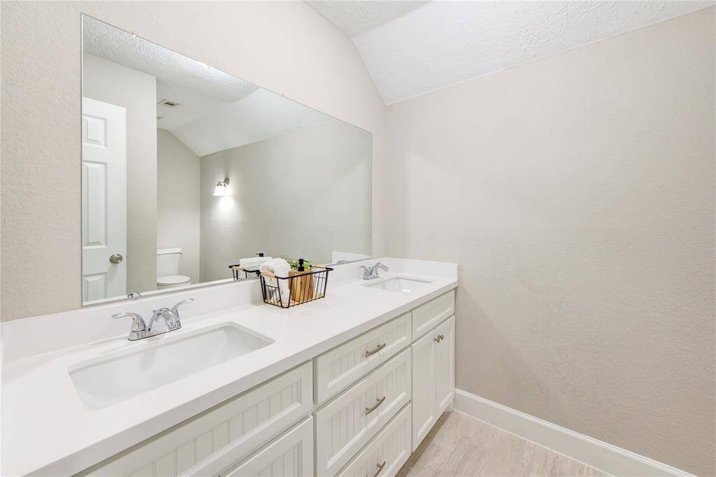 Check out this huge guest bath with dual-sink vanity and custom built cabinetry.