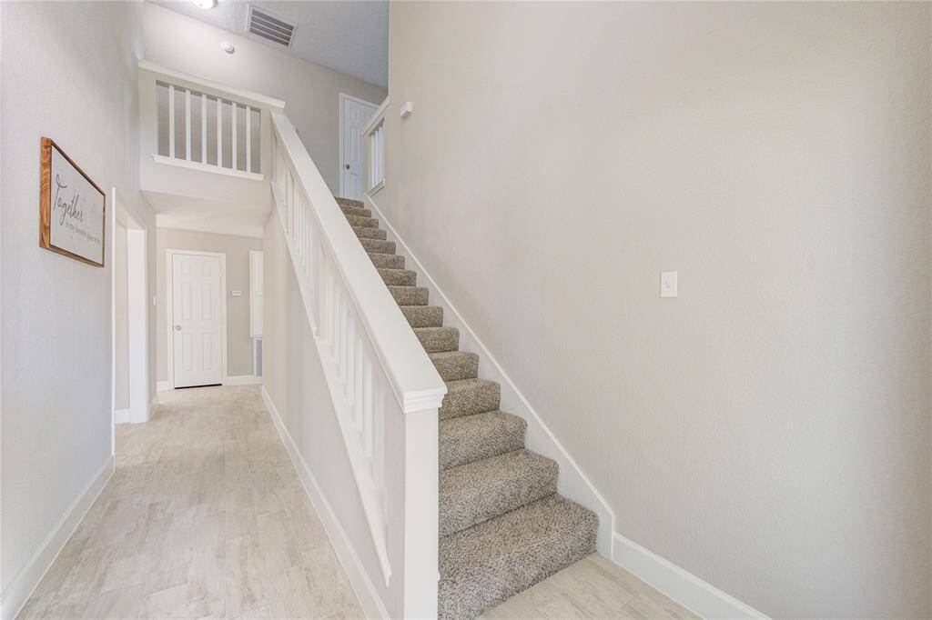 Step inside and note the gorgeous tile flooring that runs continuously throughout most of the home.