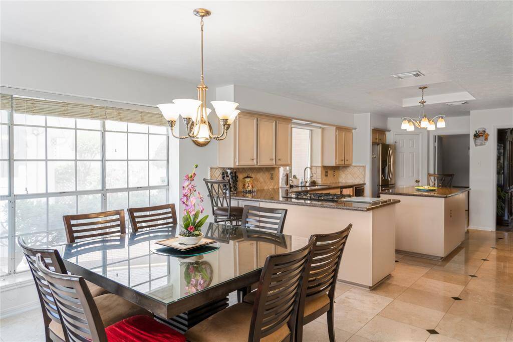 Spacious breakfast area with large windows, offering stunning views of the golf course and lake.