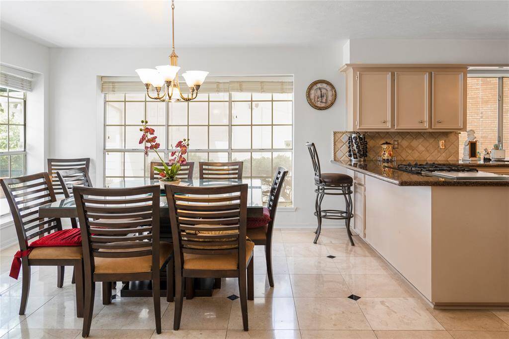 Spacious breakfast area with large windows, offering stunning views of the golf course and lake.