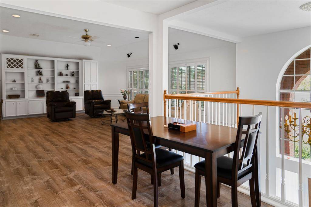 Bright and spacious game room with high ceilings, wood flooring, and large windows that let in plenty of natural light. Features a cozy seating area—perfect for entertaining guests or spending quality time with family.