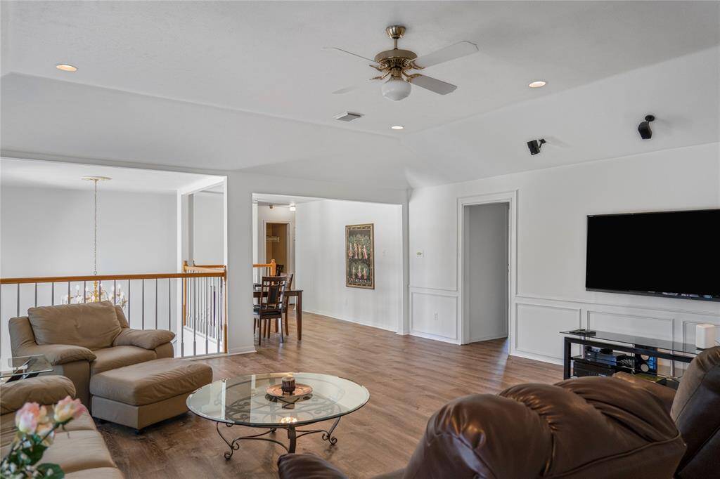 The perfect game room for board games, entertainment, and spending quality time with family and friends. It features built-in surround sound, plantation shutters, and elegant wooden shelving for added functionality and style.