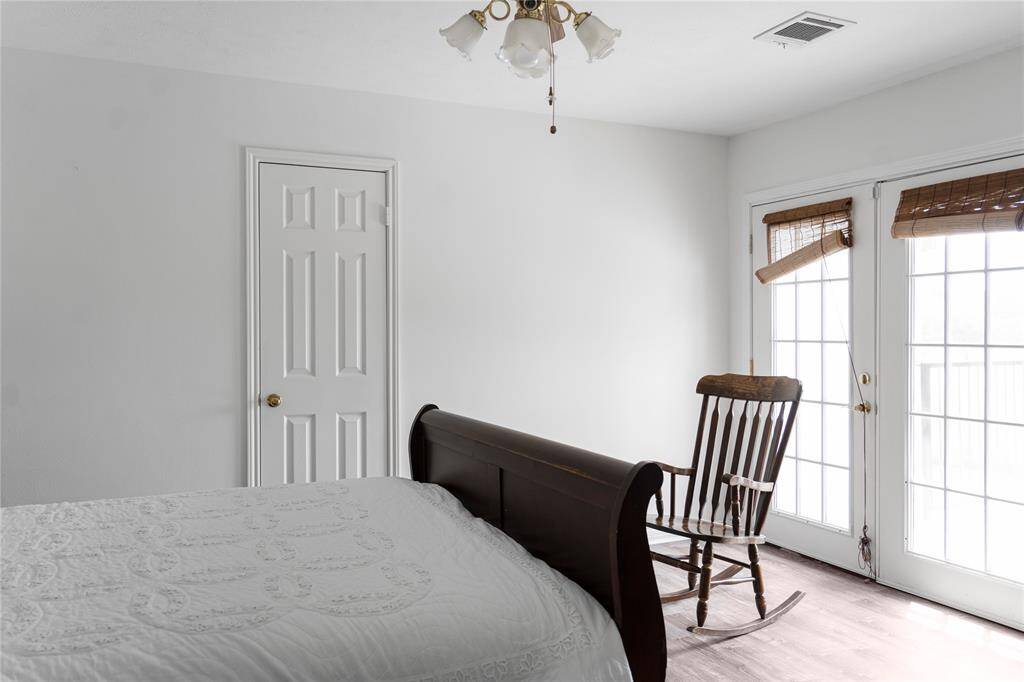 This bedroom boasts a French door leading to the upper deck, creating a perfect spot to unwind after a tiring day and witness the breathtaking sunset.