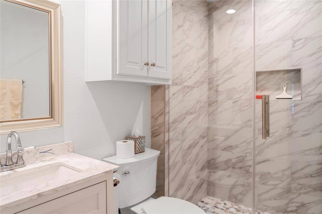 Look at the newly updated bathroom with walk-in shower and frameless glass door!
