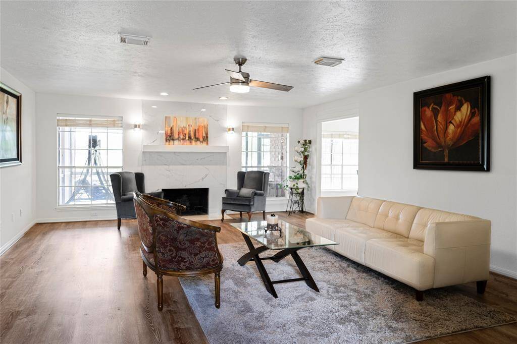 Living room with large windows offering stunning views of the golf course.