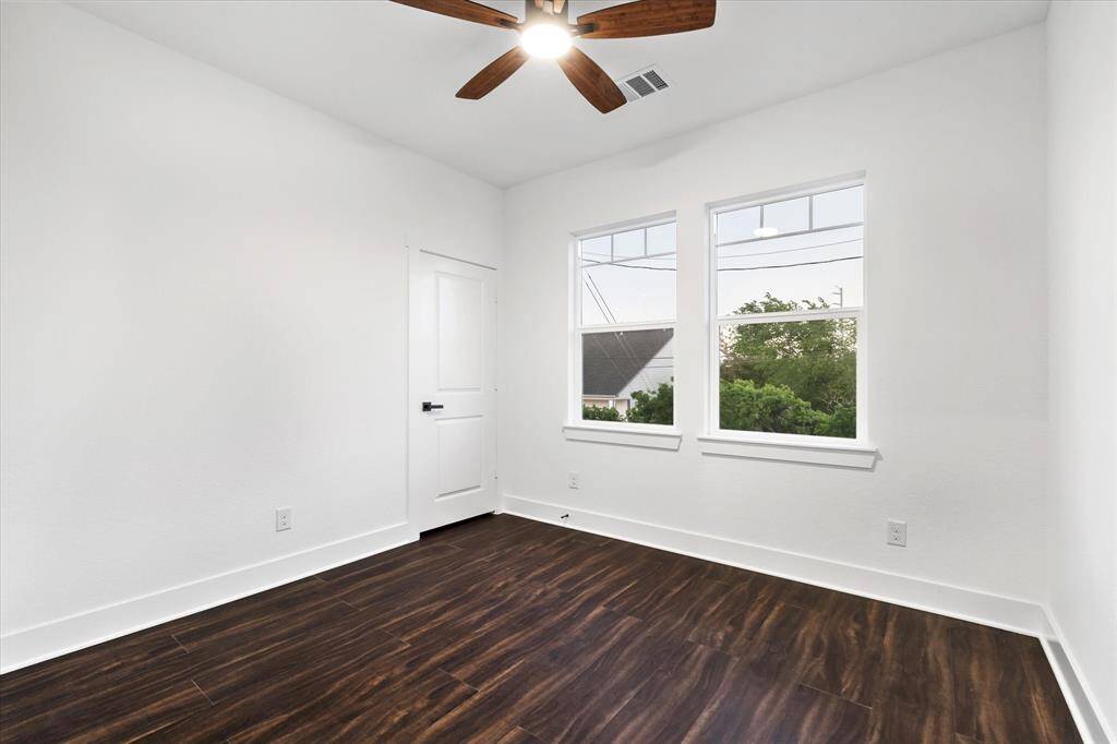 Bedroom three, much like bedroom two, has rear-facing windows, a ceiling fan for a breeze, and a large closet to keep your space tidy.