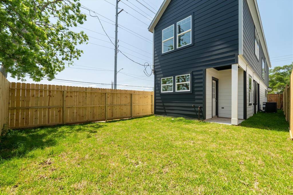 The backyard is completely fenced in, with a covered patio that’s perfect for enjoying the outdoors, rain or shine.