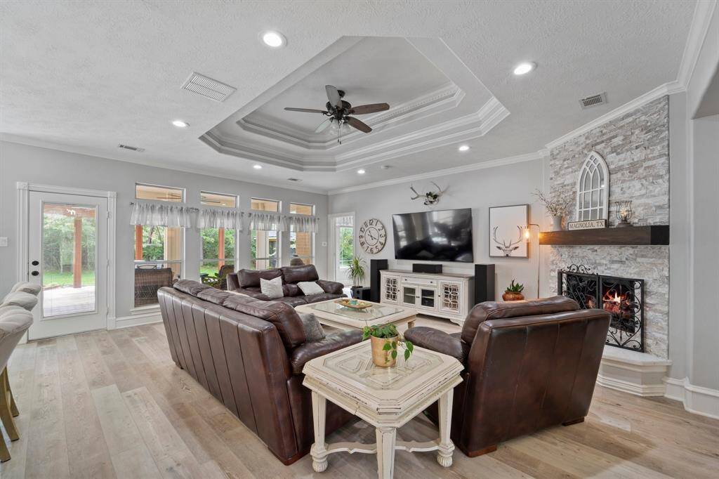Spacious family room complete with a modern stone fireplace and wood mantle, and plenty of wall space for a large tv for your movie nights.