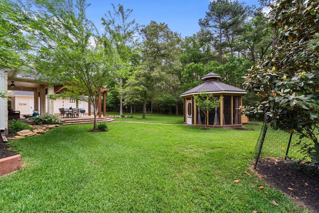 Further out in the backyard is a separate screened in gazebo.
