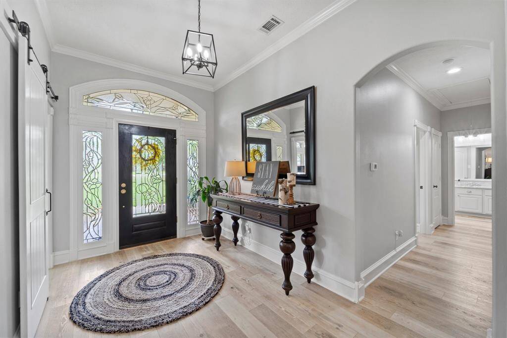 Front door is surrounded with this beautiful glass allowing natural light into the home and adds an elegance to the front entry.
