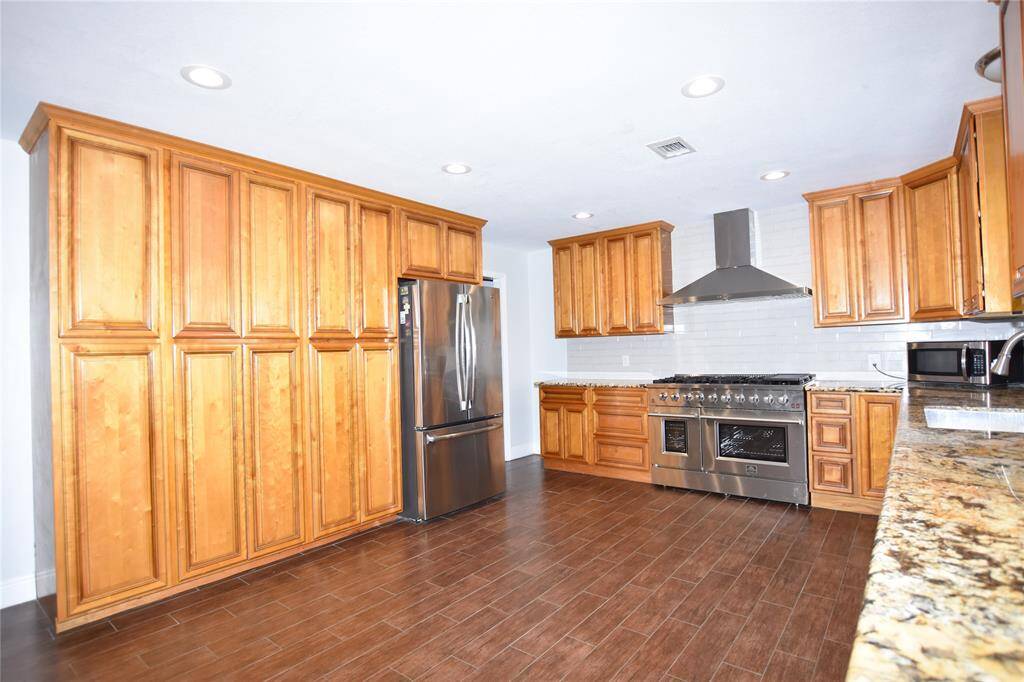 This large kitchen is the heart of the home, offering ample storage with abundant cabinetry and countertop space for all your cooking essentials.