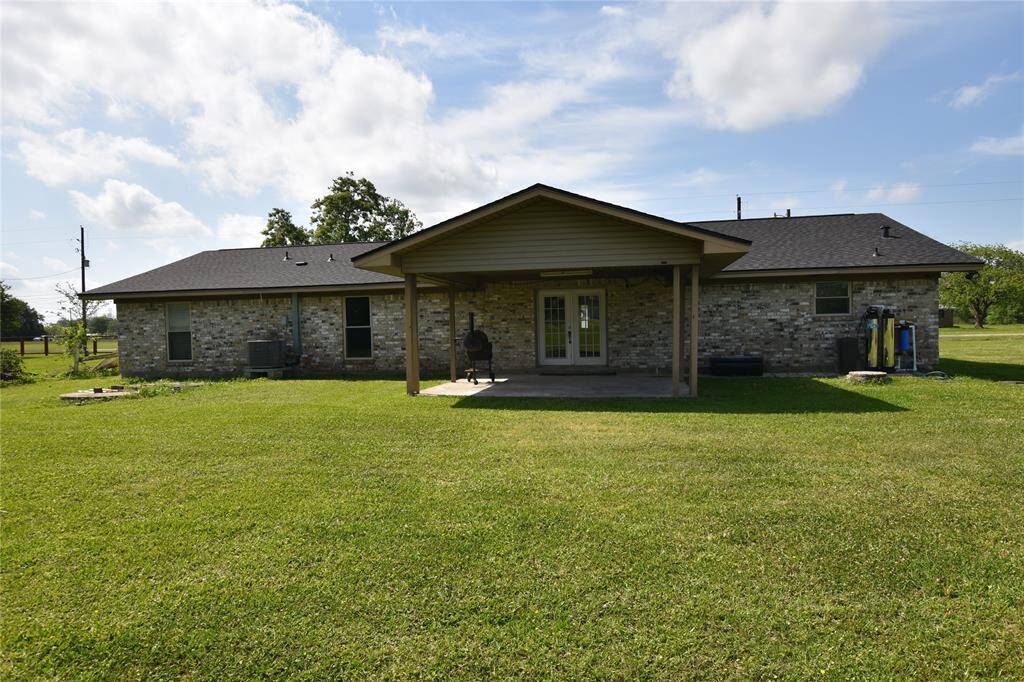 Step outside to a massive covered back patio, offering plenty of space to relax, dine, or entertain while enjoying the peaceful surroundings.