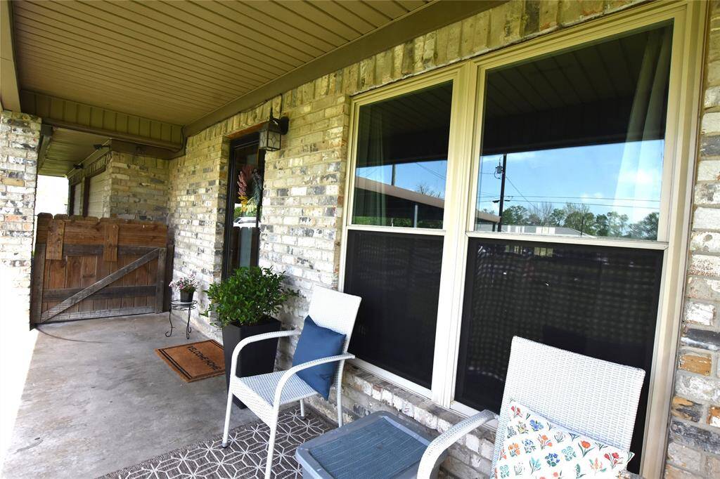 Welcome guests with Southern charm on this spacious covered front porch, offering plenty of room for comfortable seating.