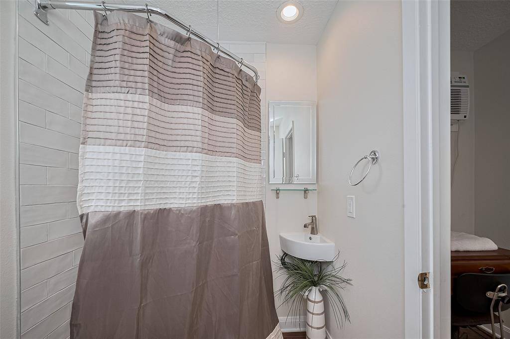 Attached studio apartment shower bath.