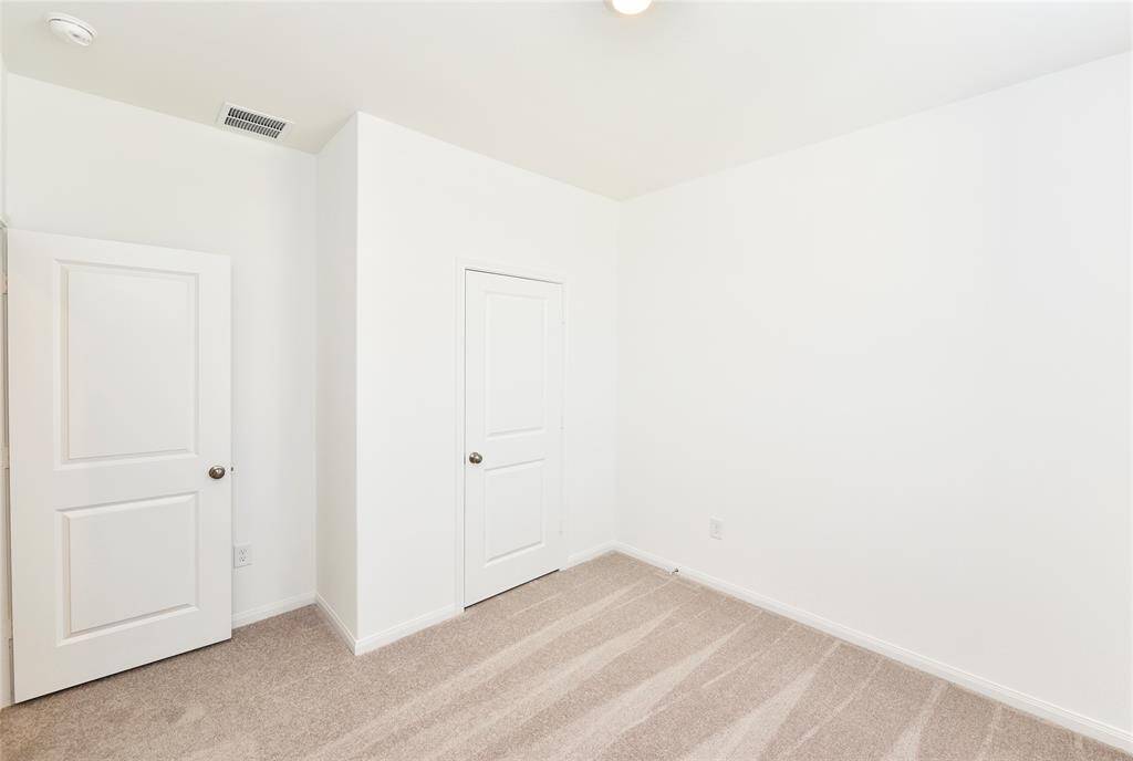 Just off the entry is a secondary bedroom. This space would also make a great office or playroom.