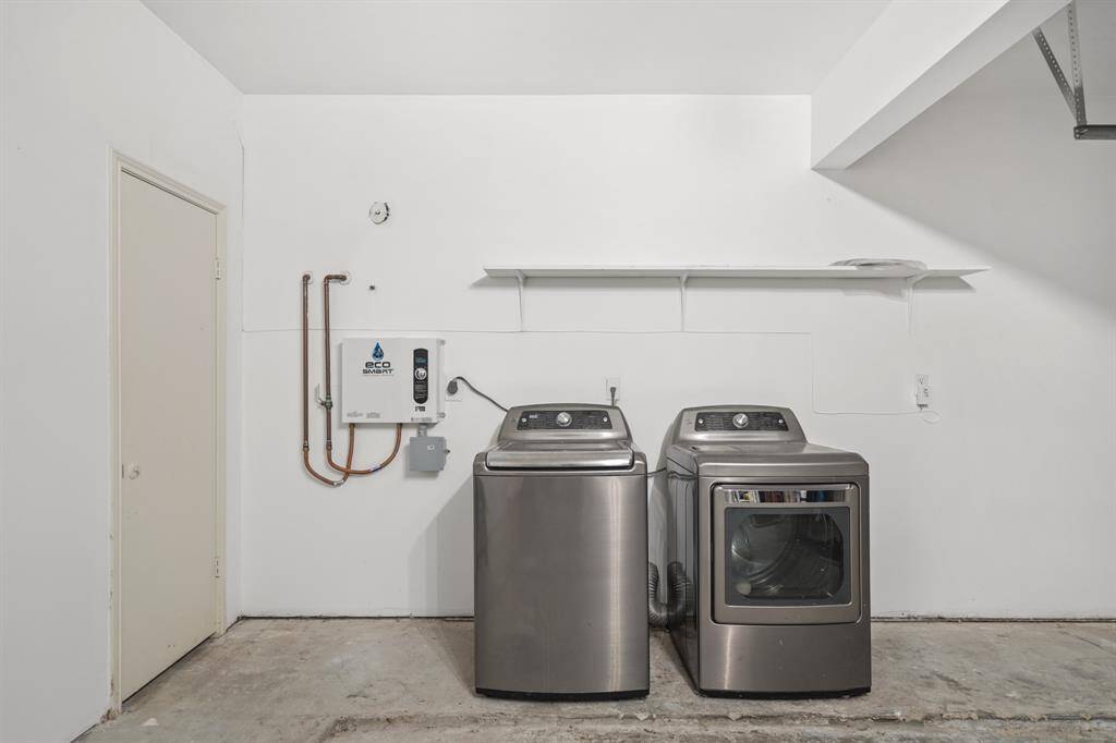 The laundry is located in the spacious 2-car garage. Yes, that is a tankless water heater!