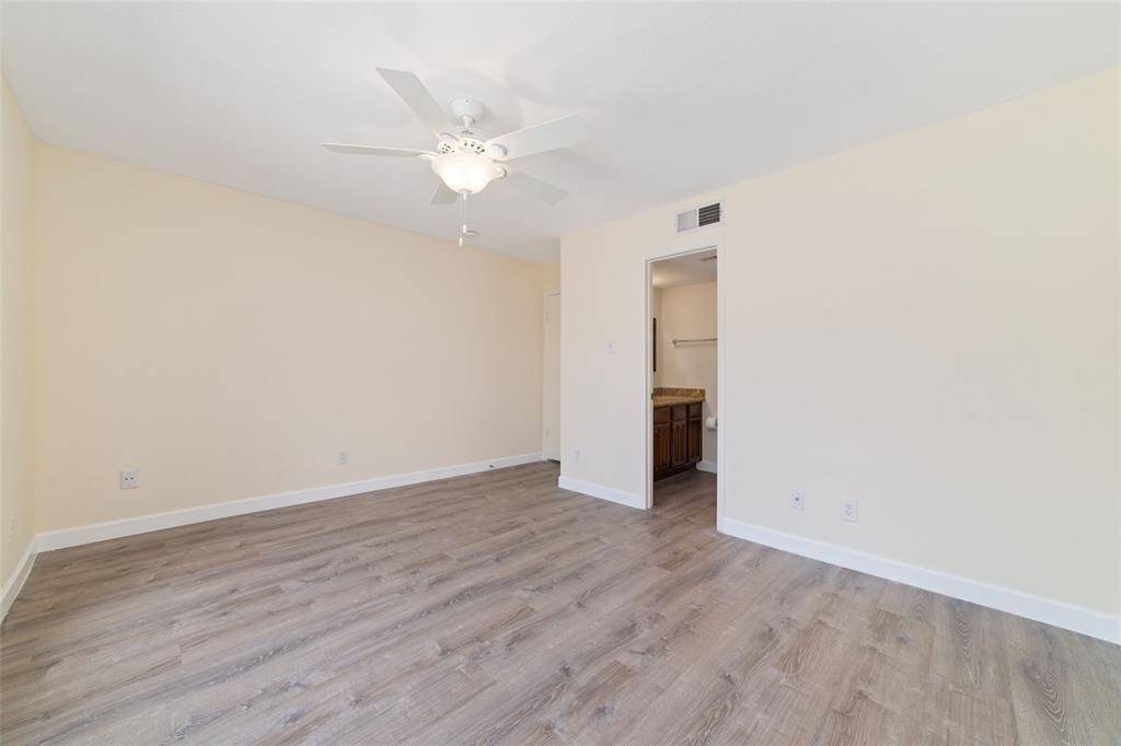 This secondary bedroom feels like a second primary suite, complete with its own en-suite bathroom for added convenience and privacy!