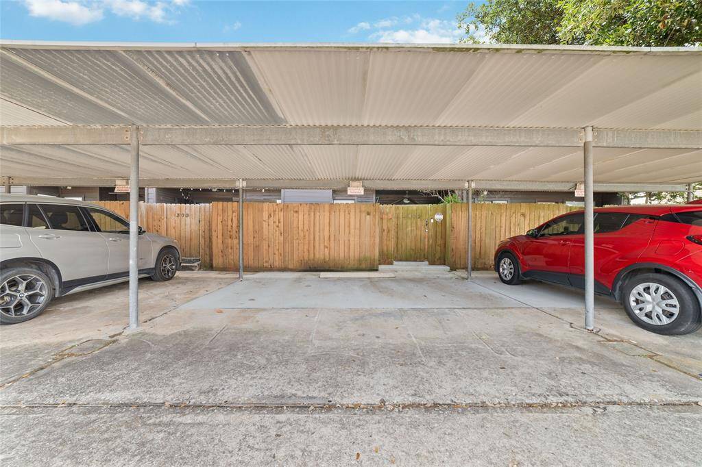 A carport with two assigned stalls provides sheltered parking beneath a durable metal roof, conveniently located right behind the unit for easy access.