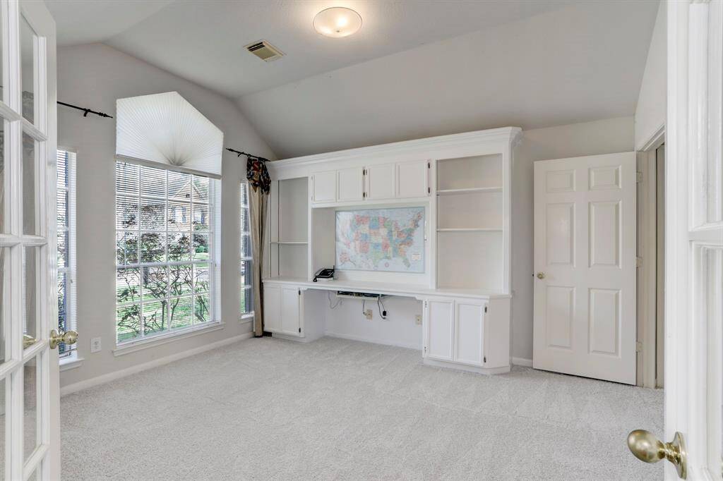 THE OFFICE FEATURES A CUSTOM BUILT-IN DESK AND BOOKCASE.