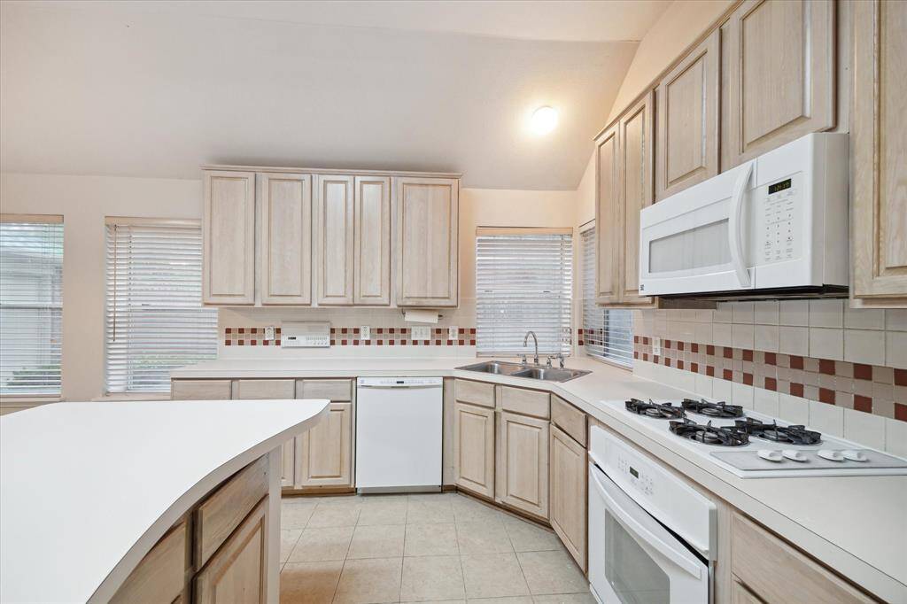 THE KITCHEN ALSO FEATURES A GAS RANGE AND PLENTY OF STORAGE.
