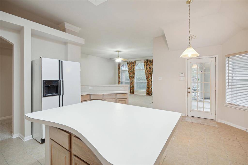 THE KITCHEN INCLUDES A BREAKFAST BAR AND OVERLOOKS THE DEN FOR A NICE, OPEN FLOORPLAN.