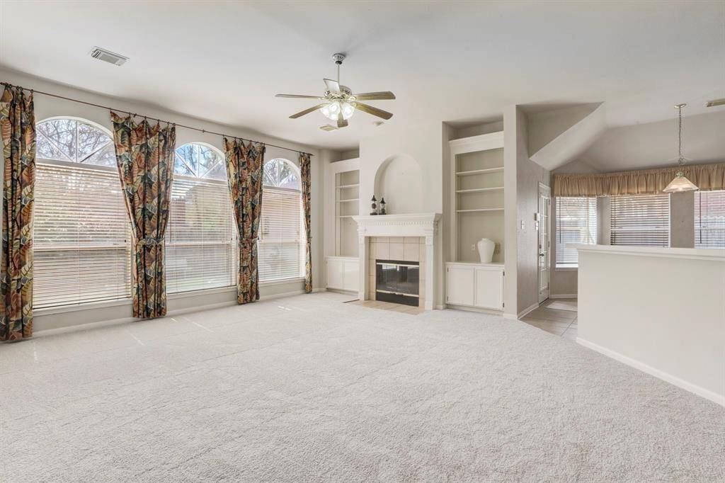 THE DEN ALSO FEATURES BUILT-INS AND A GAS-LOG FIREPLACE.