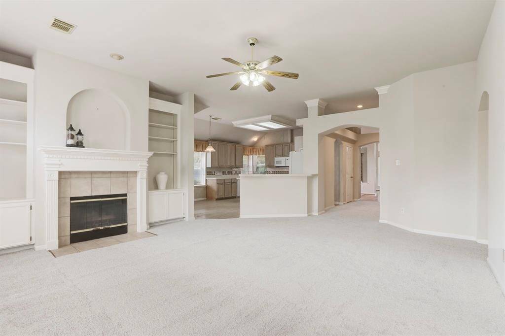 VIEW OF THE KITCHEN FROM THE DEN HIGHLIGHTS THE OPEN FLOORPLAN