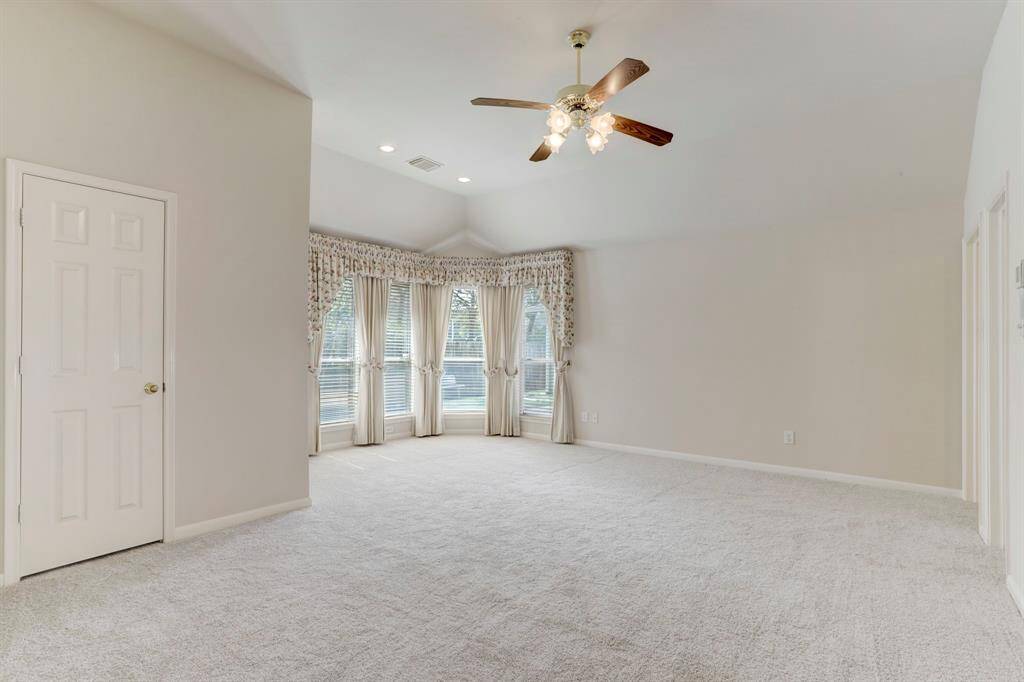 THE PRIMARY SUITE ALSO OFFERS A SITTING AREA AND WALK-IN CLOSET.