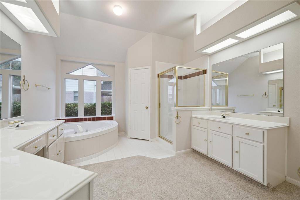 VIEW OF THE OVERSIZED SOAKING TUB AND WALK-IN SHOWER.