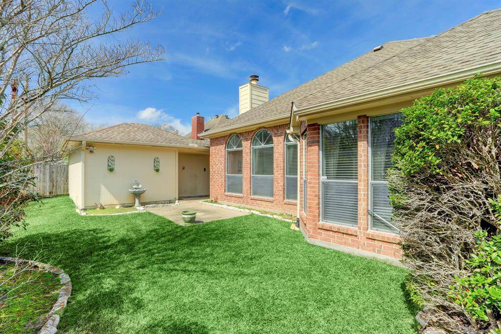 REAR ELEVATION WITH THE GARAGE IN THE BACKGROUND.