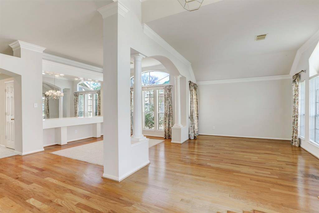 BOTH FORMALS FEATURE HARDWOOD FLOORS AND BEAUTIFUL ARCHES.