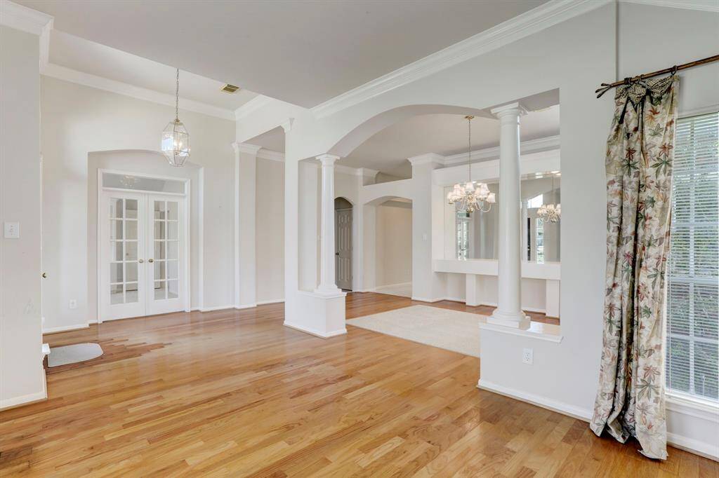 FORMAL LIVING ROOM OPENS TO THE DINING ROOM WITH THE OFFICE IN THE BACKGROUND.