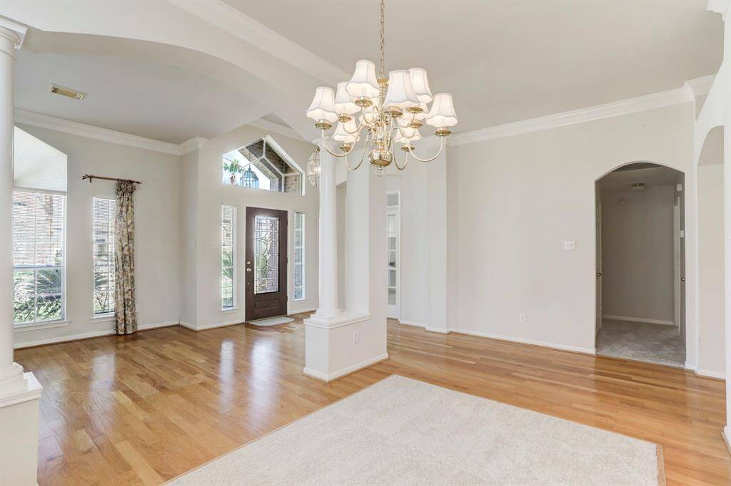 ANOTHER ANGLE OF THE FORMAL DINING ROOM WITH THE ENTRY AND OFFICE IN THE BACKGROUND.