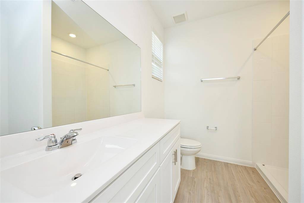Primary bathroom with extended marble counter tops.