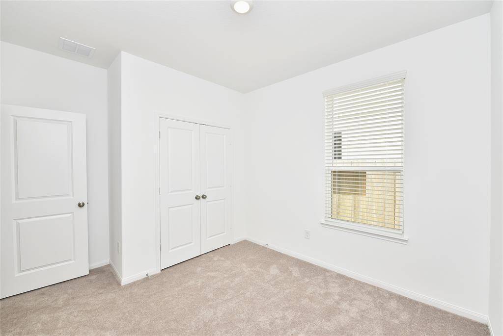 This secondary bedroom is located in the front of home allowing privacy for the primary and includes a spacious double wide closet.