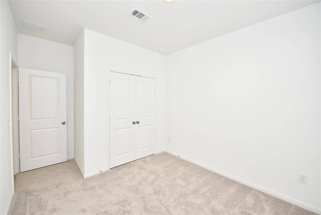 A third bedroom is also located near the front of the home and has a double wide closet and easy access to the hall bath.