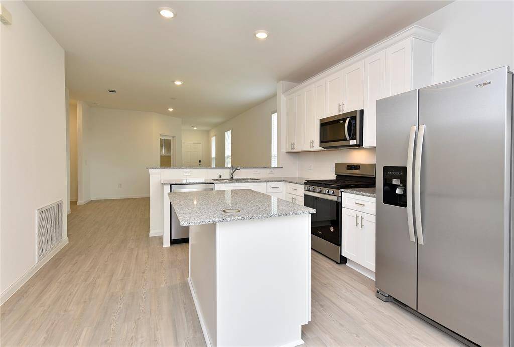 Kitchen open to the family room. BRAND NEW appliances including stainless steel dishwasher, microwave, refrigerator and gas range. Plus a pantry closet and plenty of cabinets!