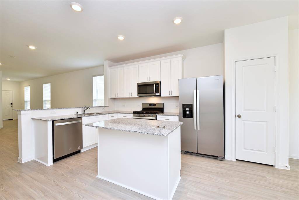 Kitchen open to the family room. BRAND NEW appliances including stainless steel dishwasher, microwave, refrigerator and gas range. Plus a pantry closet and plenty of cabinets!