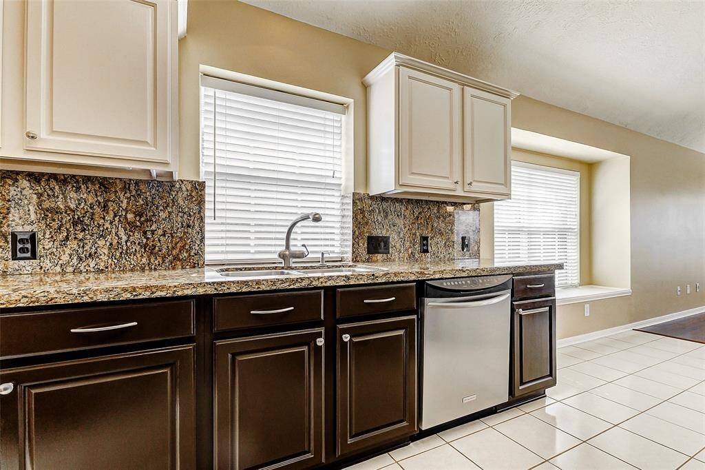 You will love the designer Grohe faucet over the double sinks. Extended window sill on the right is a cleverly integrated bench offering convenient extra seating.