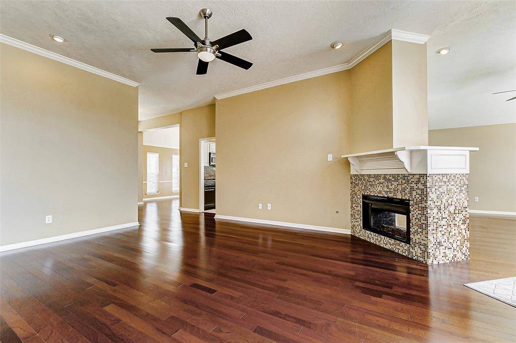 This smart floor plan places the family room in an ideal location, easily accessible from both the den and kitchen, promoting togetherness and comfortable living.