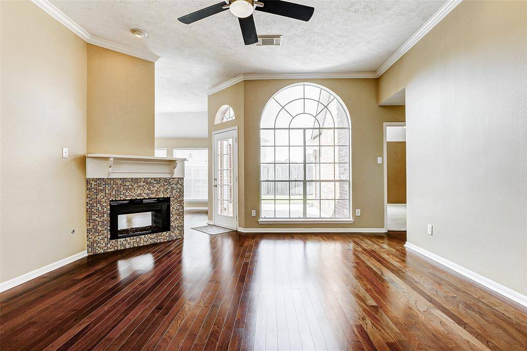Bask in the abundance of natural light that floods the family room through the expansive cathedral window and backdoor creating a bright and airy atmosphere.