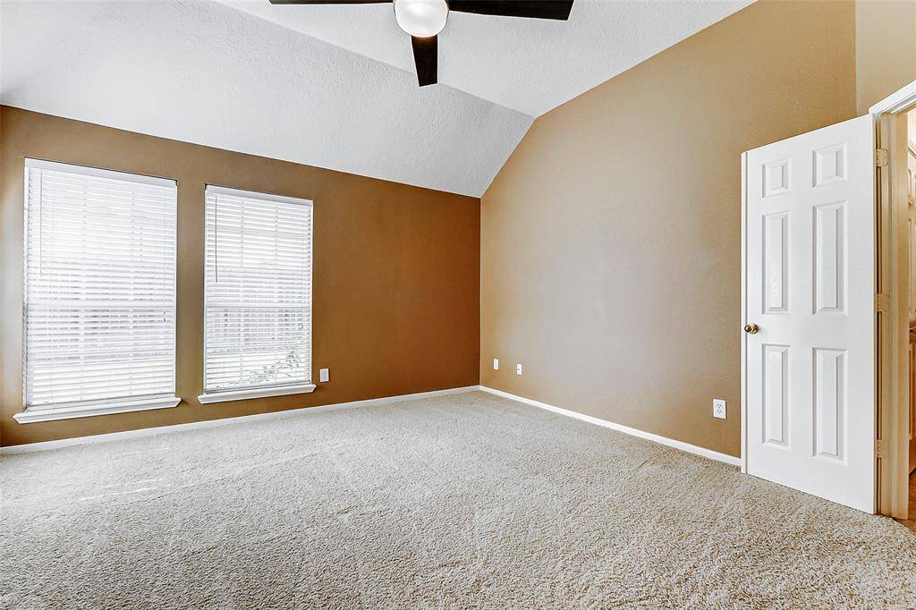 Escape to the tranquility of the spacious primary bedroom, a true retreat offering ample room to relax and recharge.