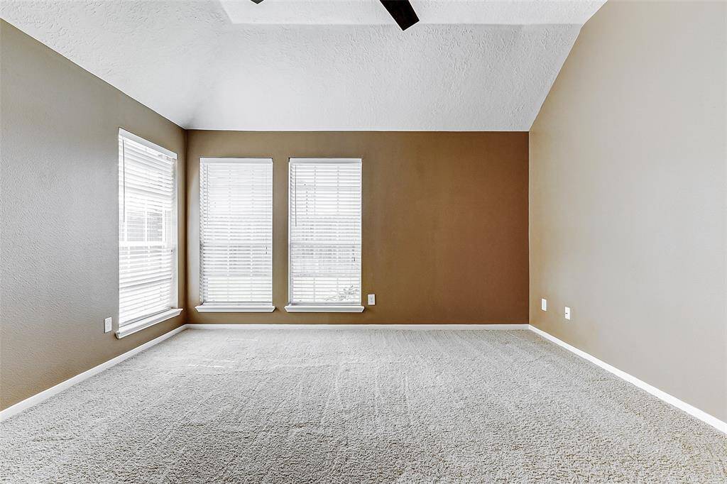 The spacious primary bedroom will easily accommodate all your furnishings. Bathed in natural light streaming through three generous sized windows, creating a bright and welcoming retreat.