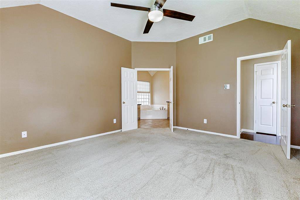 Double doors lead to the ensuite primary bathroom.