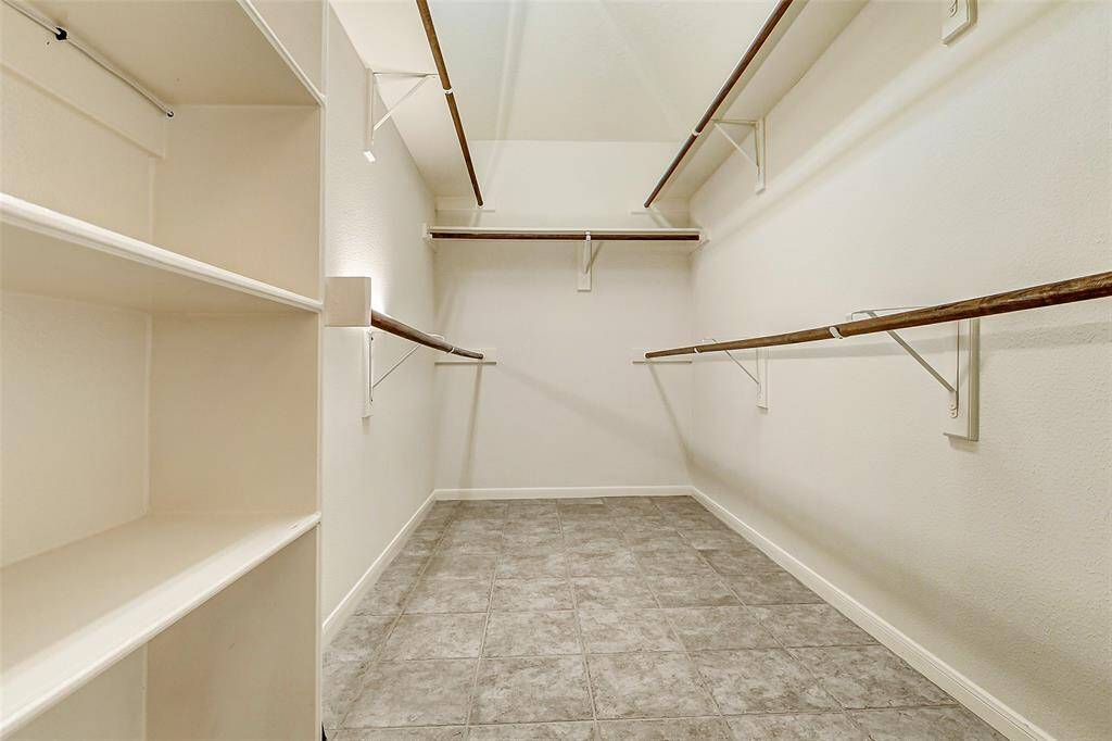 Imagine the possibilities within this sizeable primary closet, offering ample space to effortlessly organize and store your entire wardrobe.